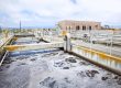 Wastewater treatment plant (WWTP) showing aeration basins and filtration systems used for water testing and contaminant removal.