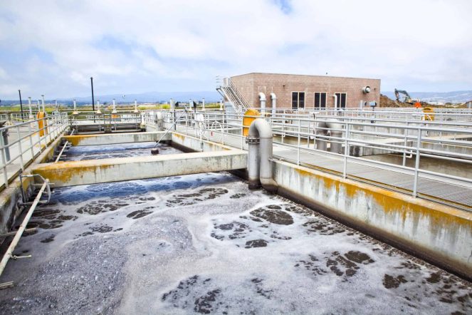 WWTP Wastewater treatment plant (WWTP) showing aeration basins and filtration systems used for water testing and contaminant removal.