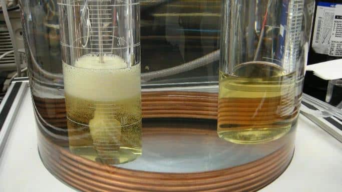 ASTM D5864 and OECD 301B biodegradability testing of lubricants showing laboratory analysis and microbial breakdown of oil in environmental conditions.